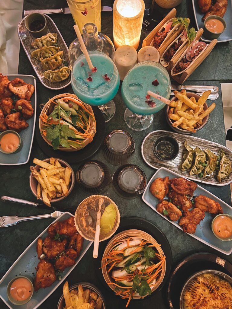 Aerial view of a colorful dinner table with various foods and drinks.